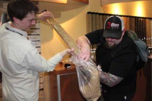 Dean (left), who manages our 300bbl brewhouse/extract plant, and Josh empty tubes of malt into bags. Each tube contained about 7 pounds of malt.